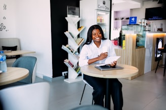 A woman sitting at a table with a laptop