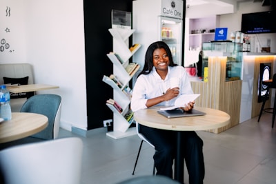 A woman sitting at a table with a laptop