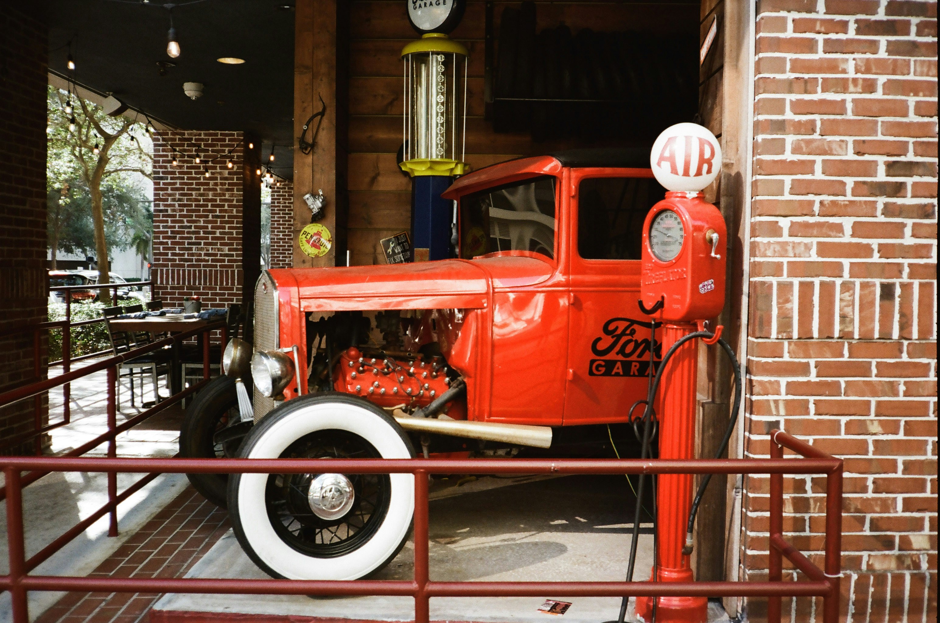 An old red truck is parked in a building