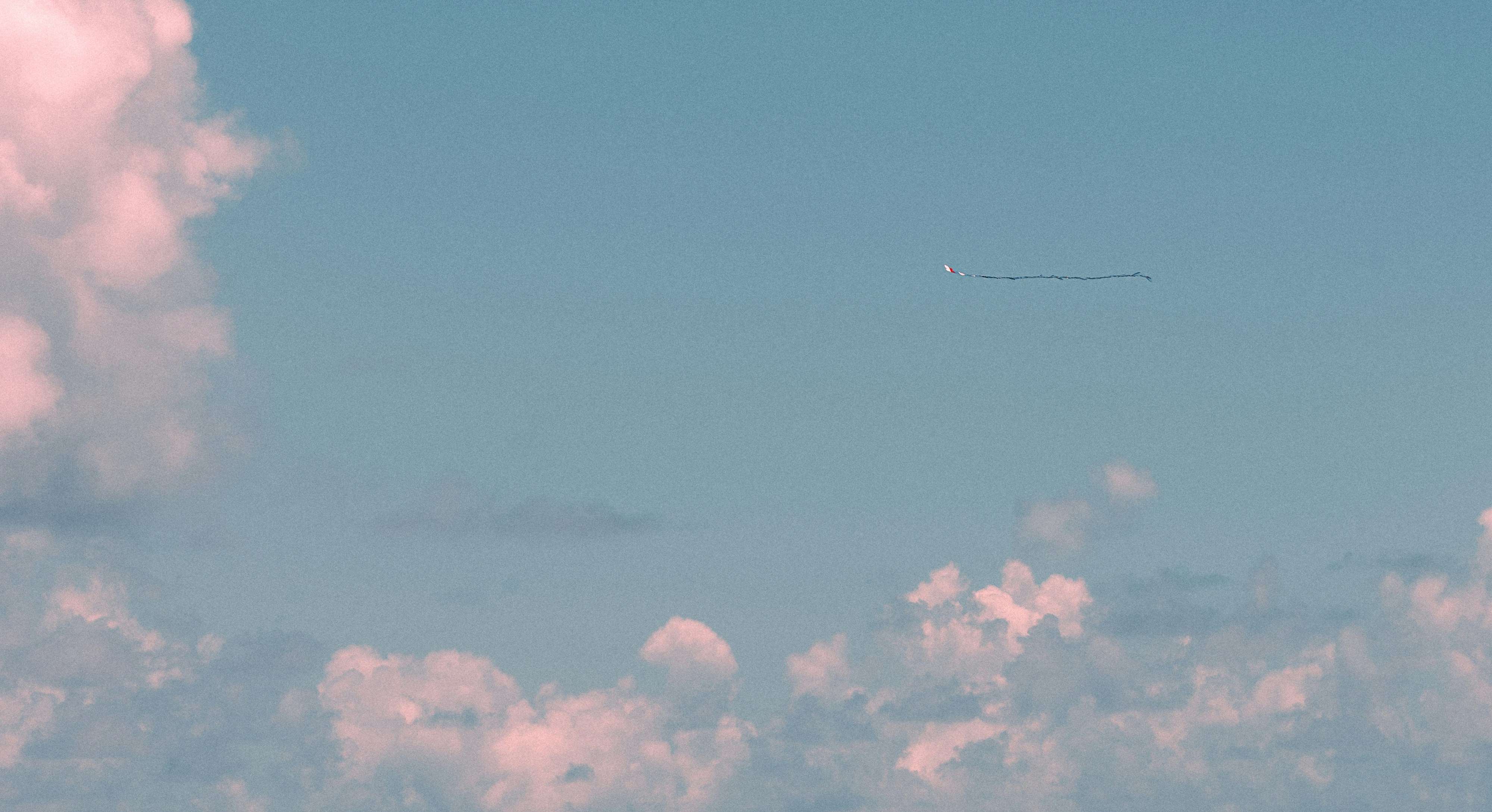 Plane flying in sky with clouds