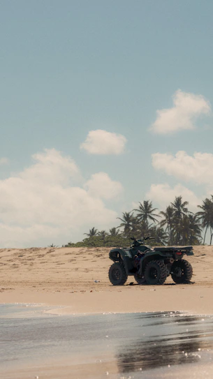 A person riding a four wheeler on the beach