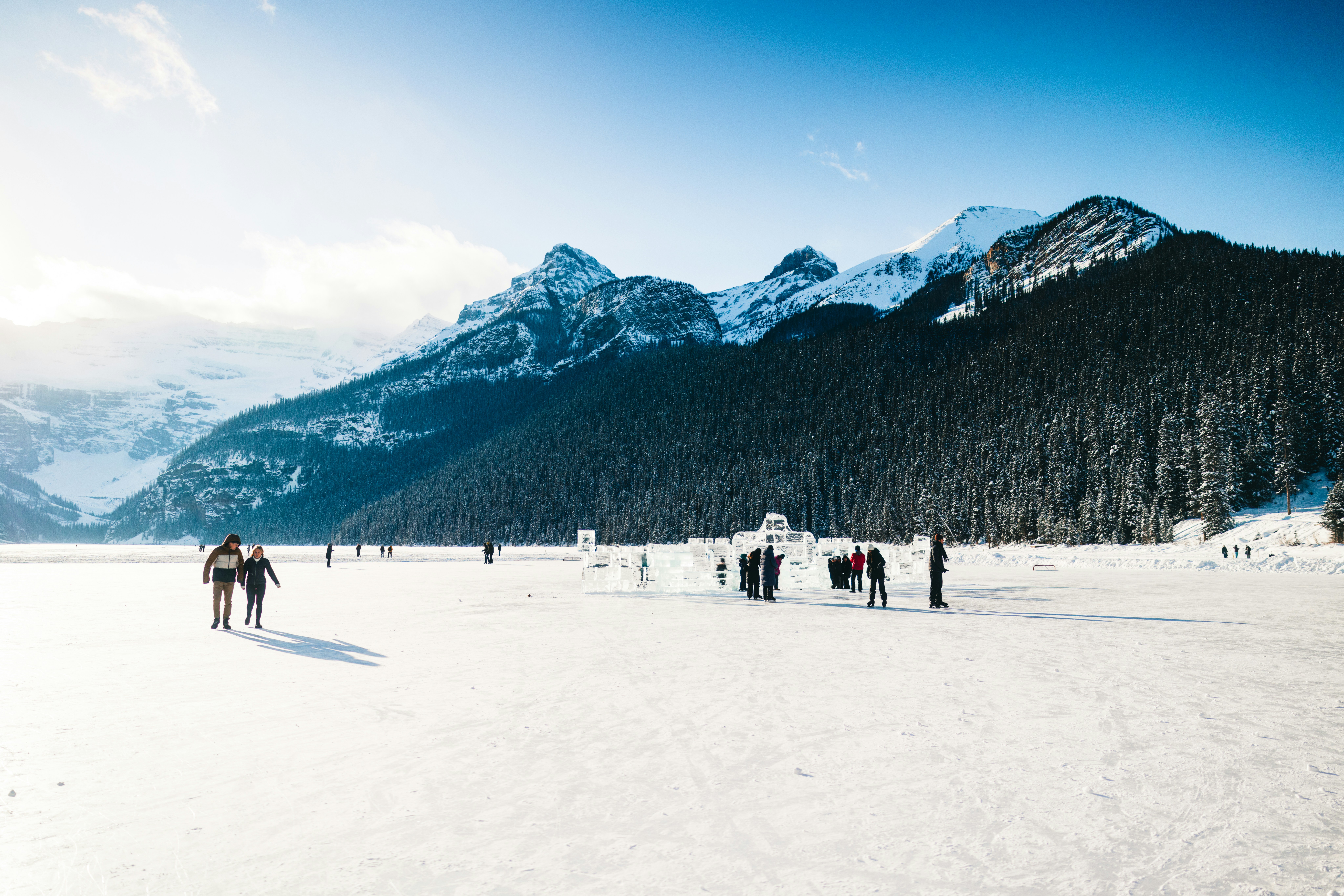 A group of people walking across a snow covered field