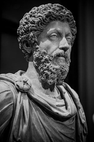 A black and white photo of a statue of a man with a beard