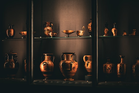 A shelf filled with lots of vases on top of shelves