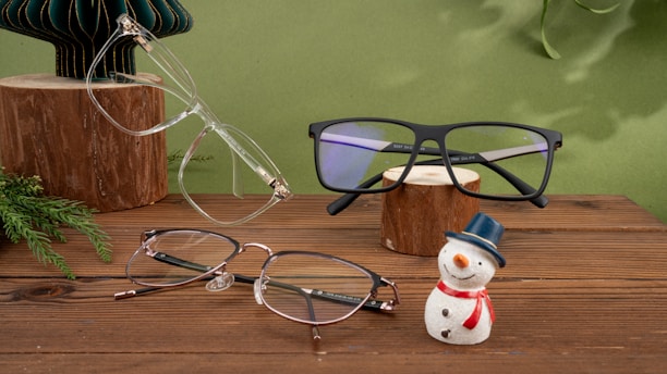 A wooden table topped with glasses and a snowman figurine