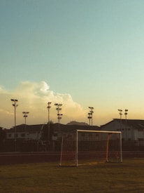A soccer field with a soccer goal and a soccer ball
