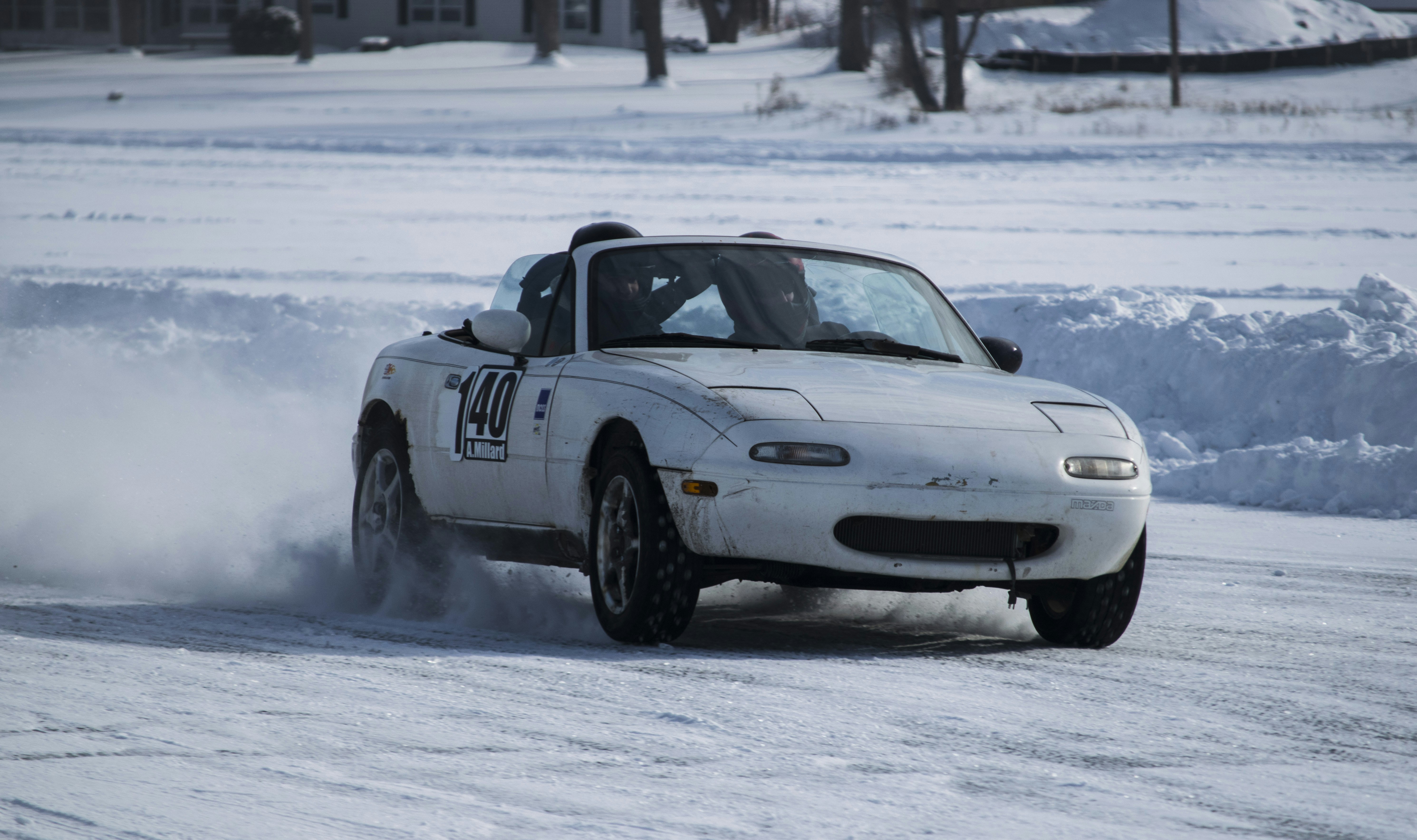 A white car driving down a snow covered road photo – Free Miata Image ...