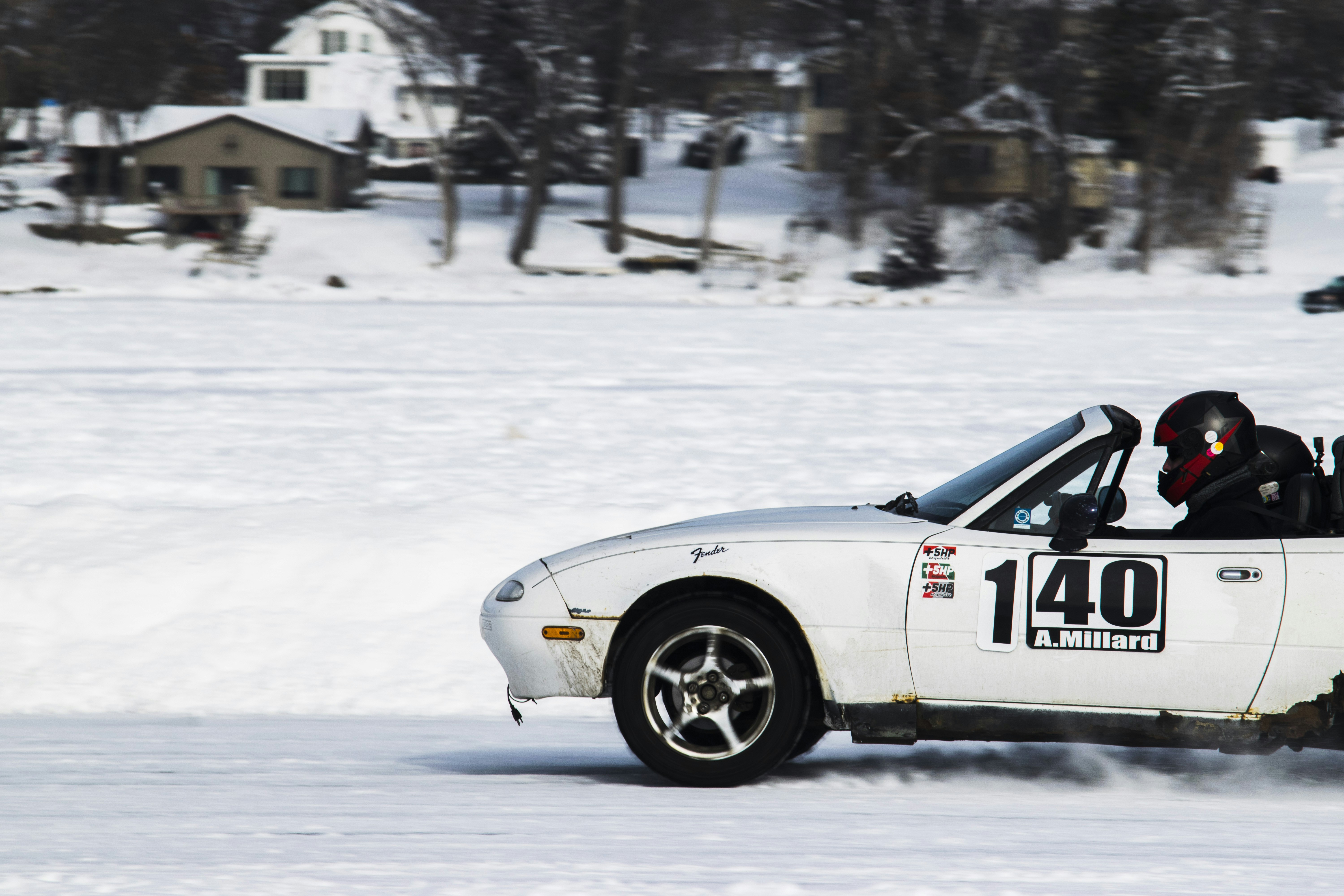 A white car driving down a snow covered road photo – Free Miata Image ...