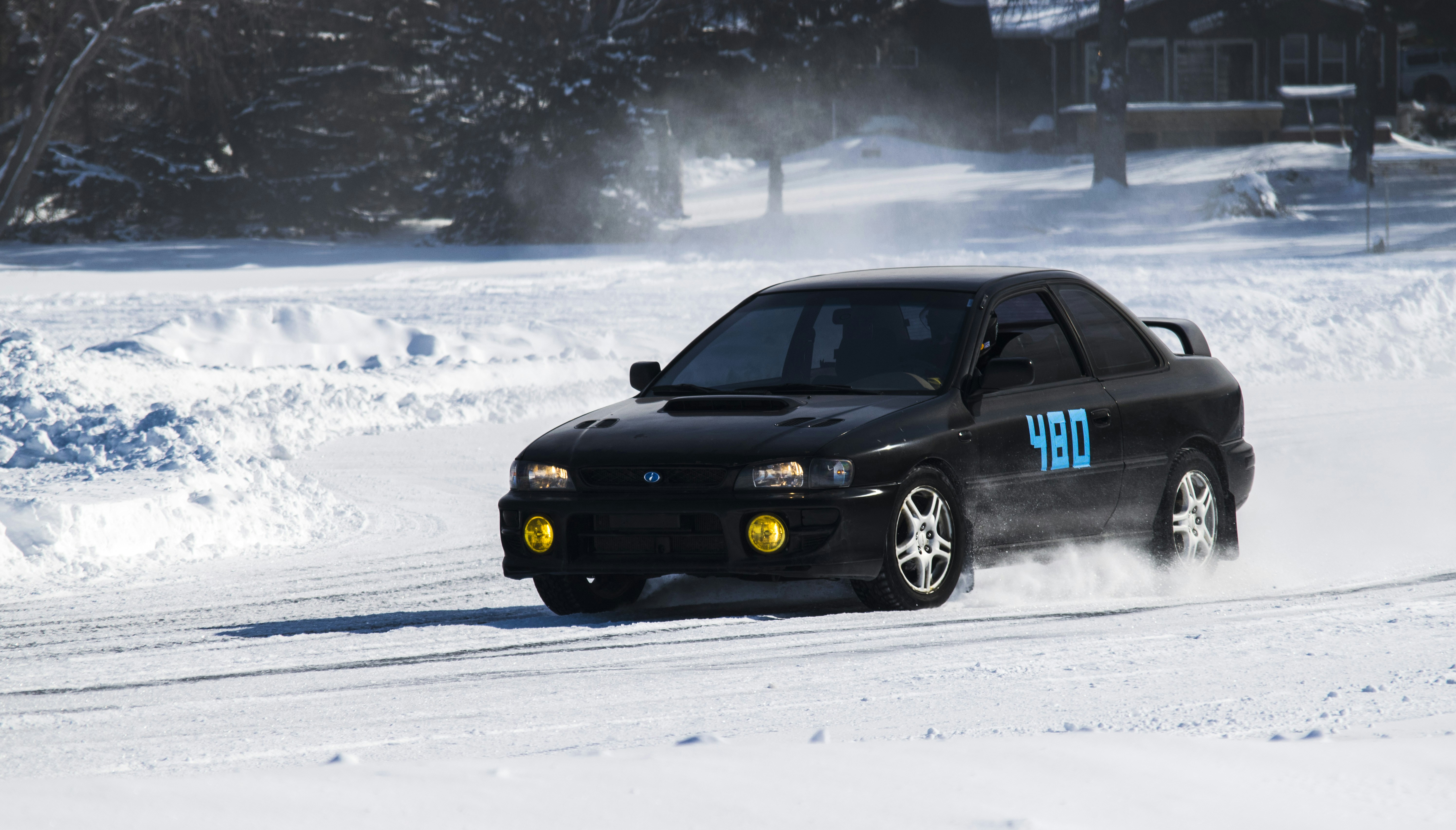 A black car driving down a snow covered road photo – Free Subaru Image ...
