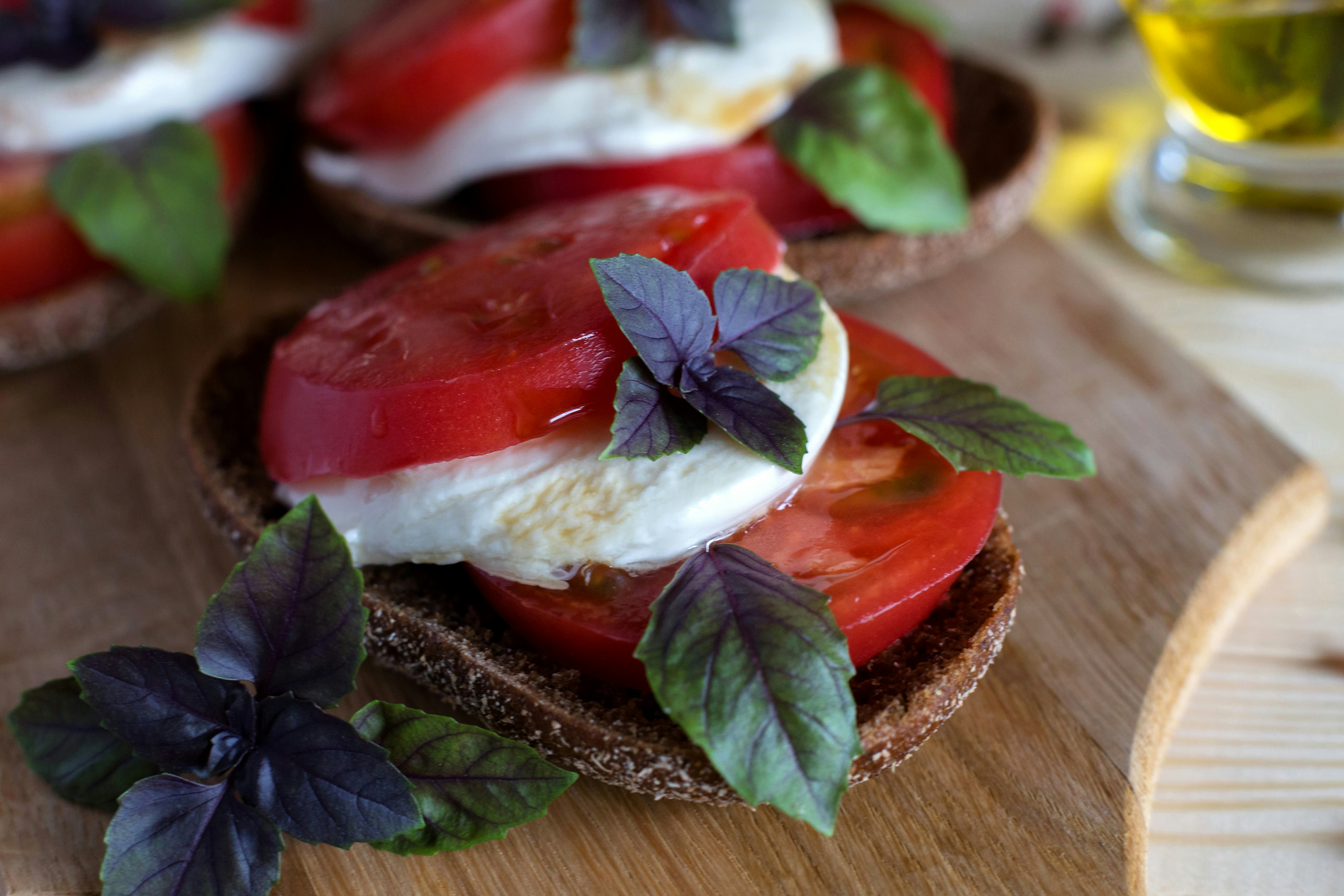 A close up of a sandwich on a wooden board