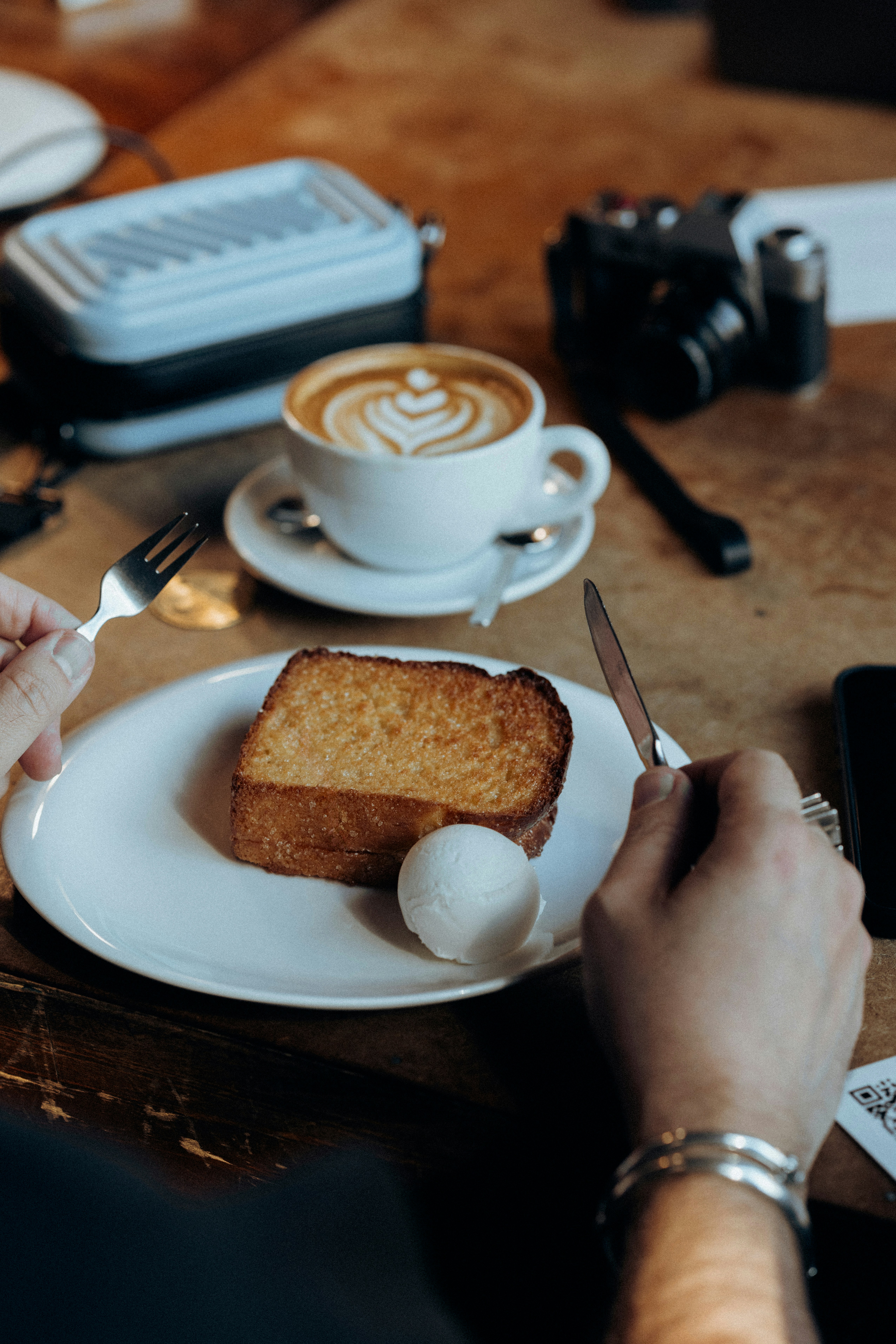 A person sitting at a table with a plate of food