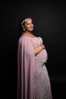A pregnant woman in a pink gown