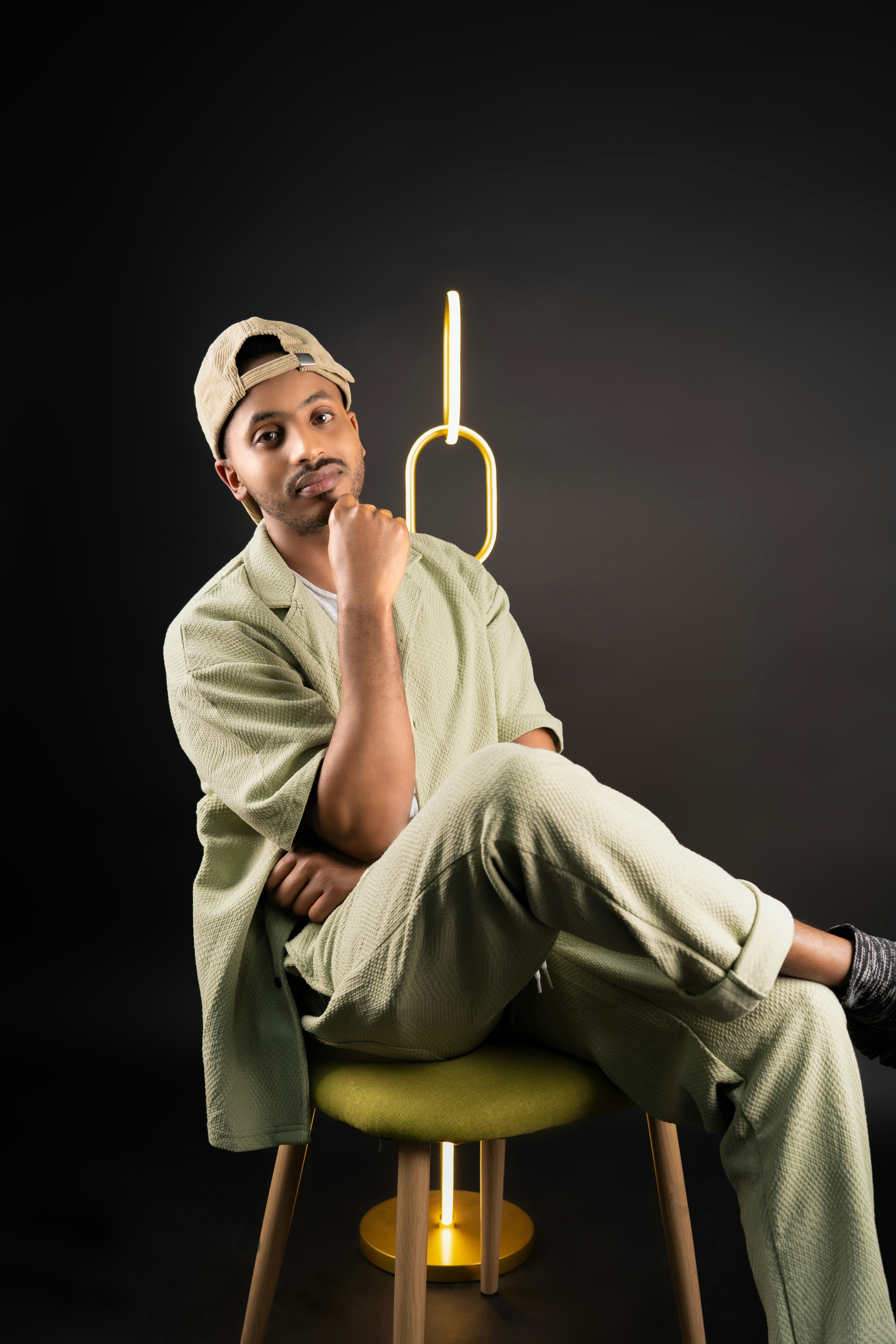A man sitting on top of a stool