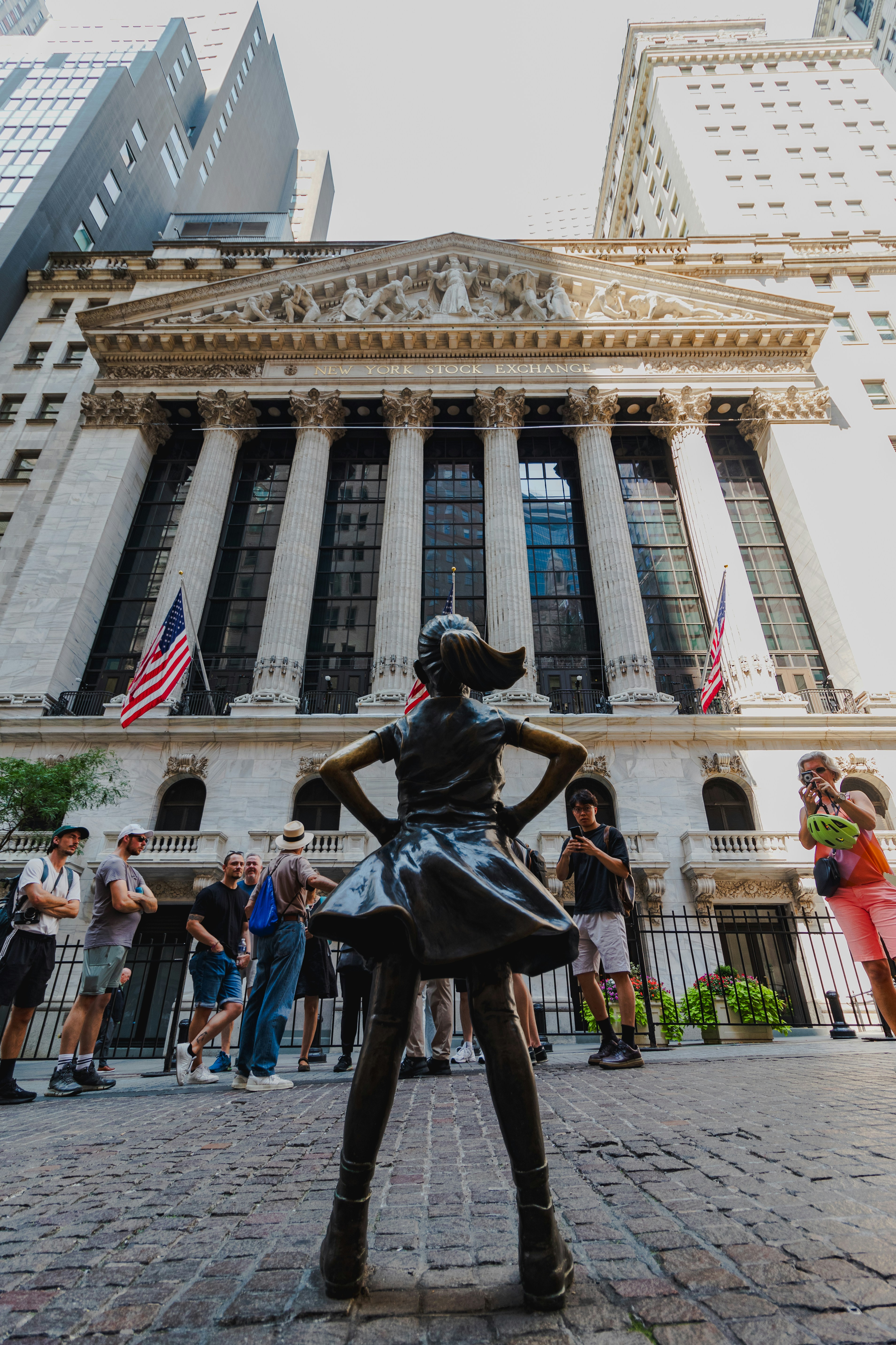 A statue of a woman standing in front of a building