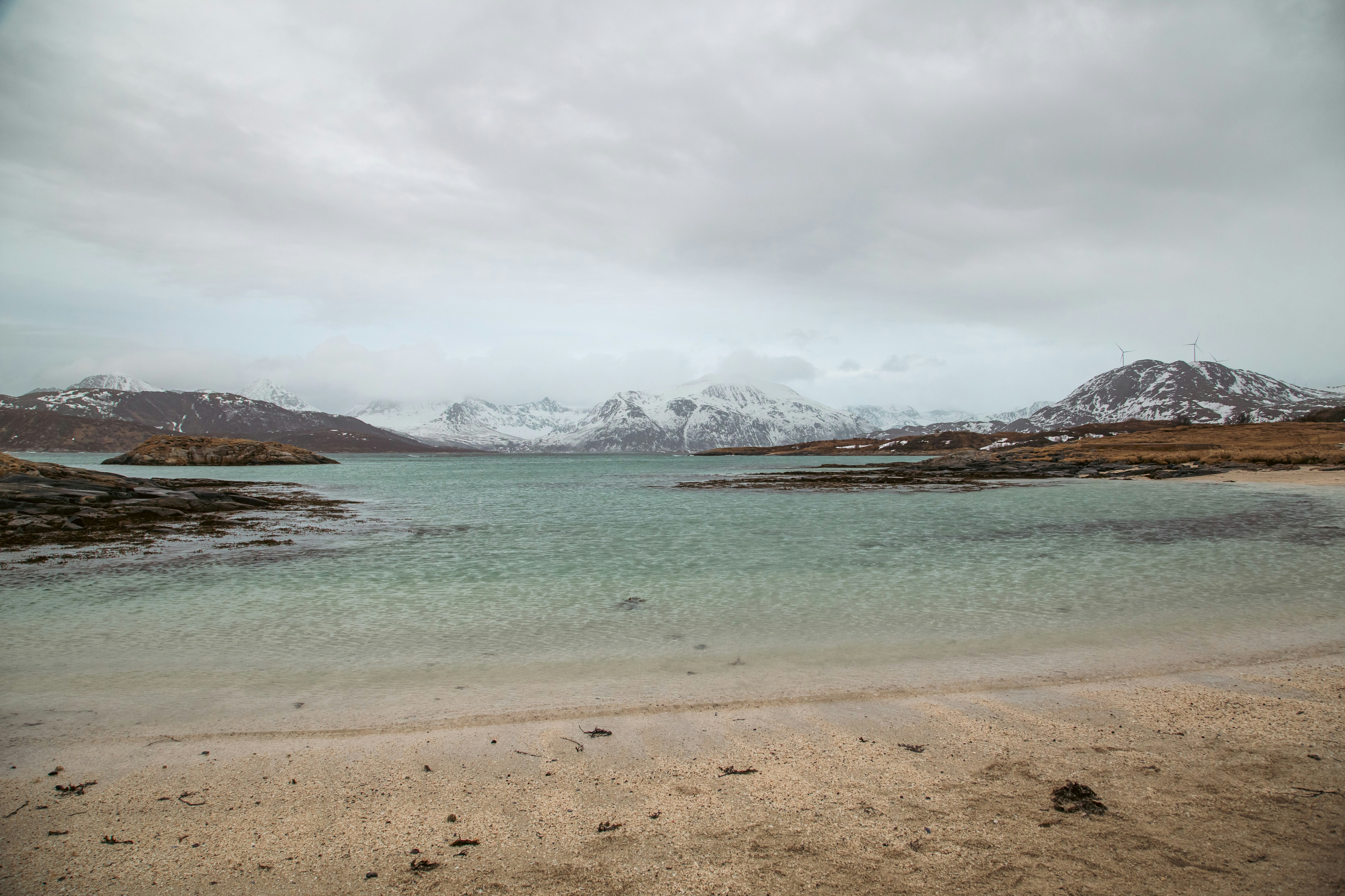 A body of water with mountains in the background