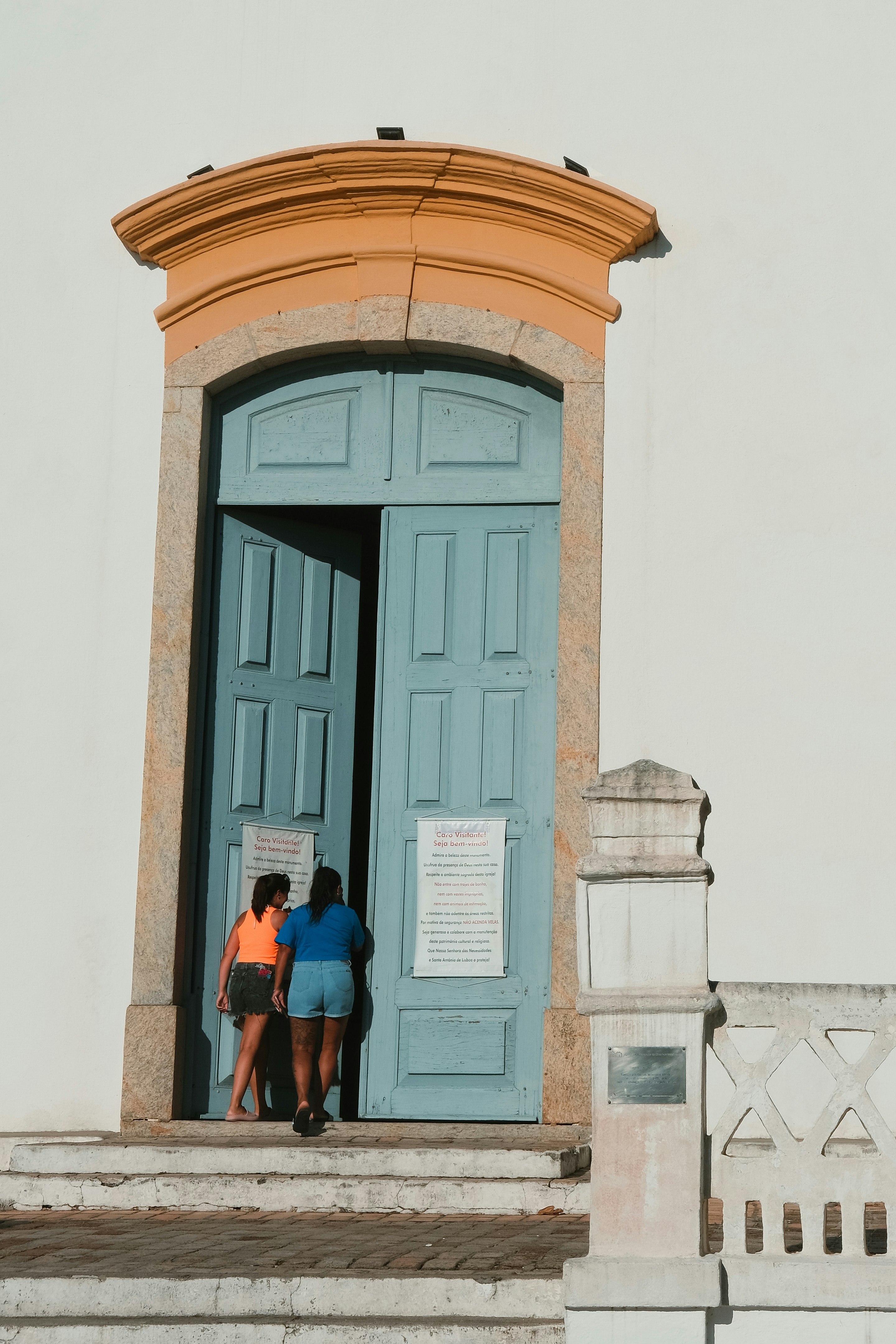 A couple of people that are standing in front of a door