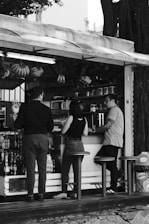 A black and white photo of people ordering food