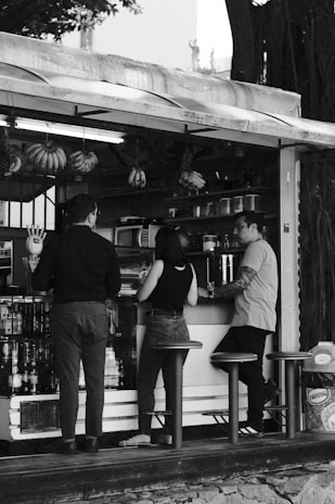 A black and white photo of people ordering food