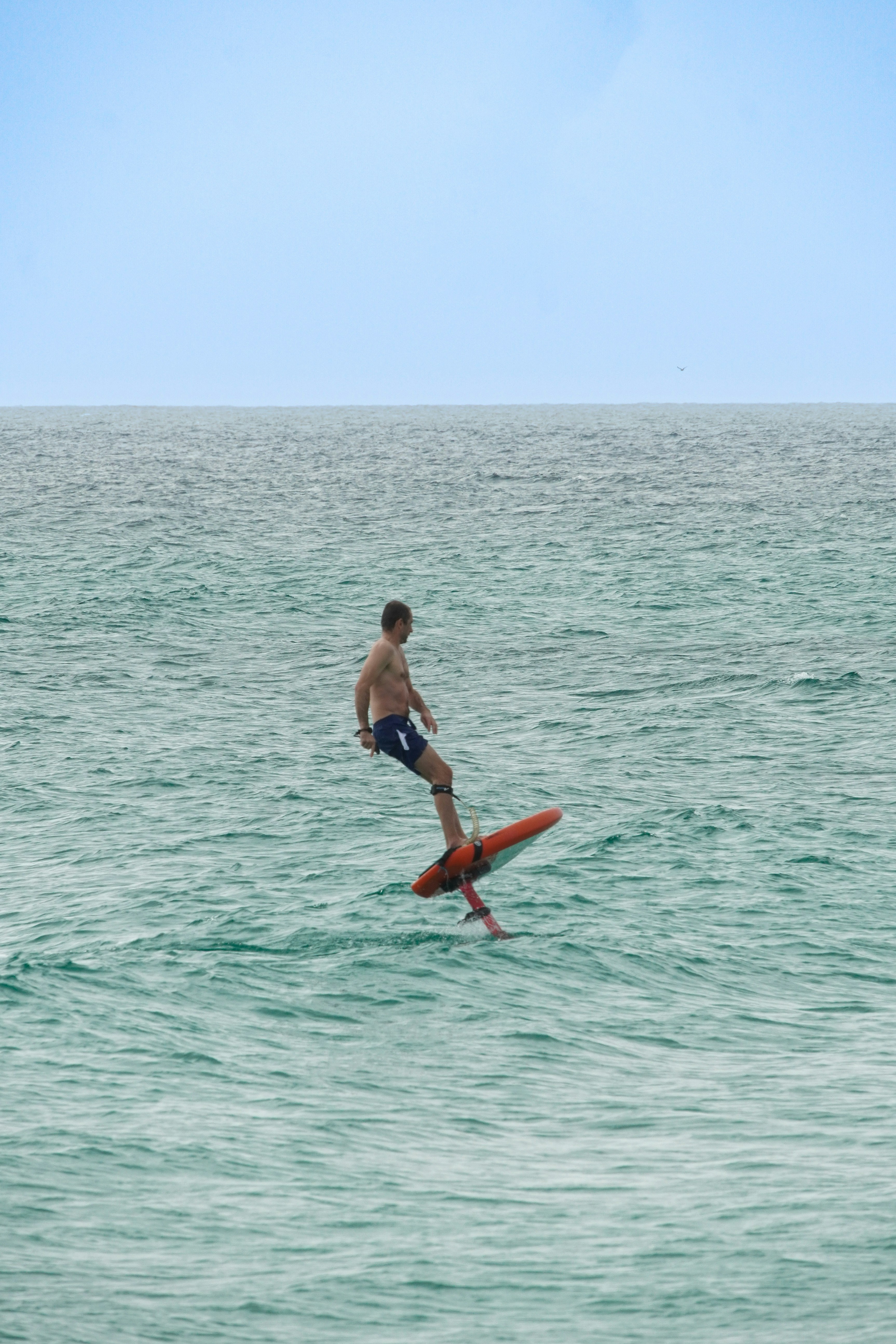 A man riding a surfboard on top of a wave in the ocean