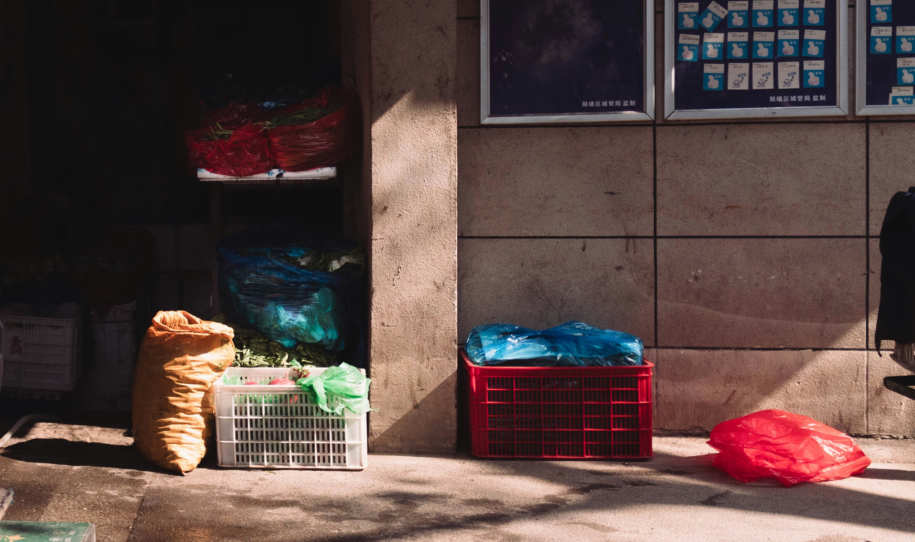 A person sitting on a bench in front of a building