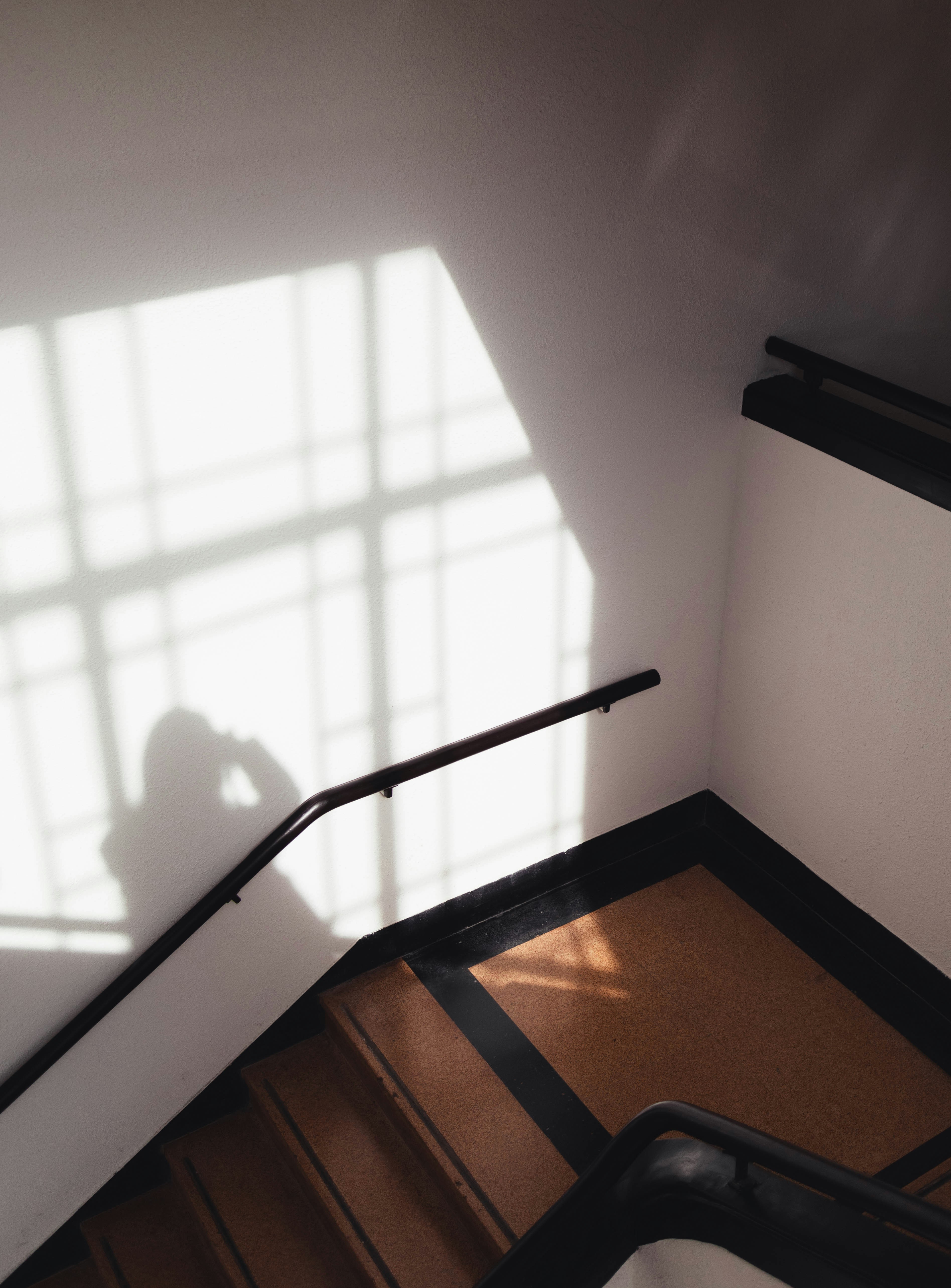 The shadow of a person standing on a stair case