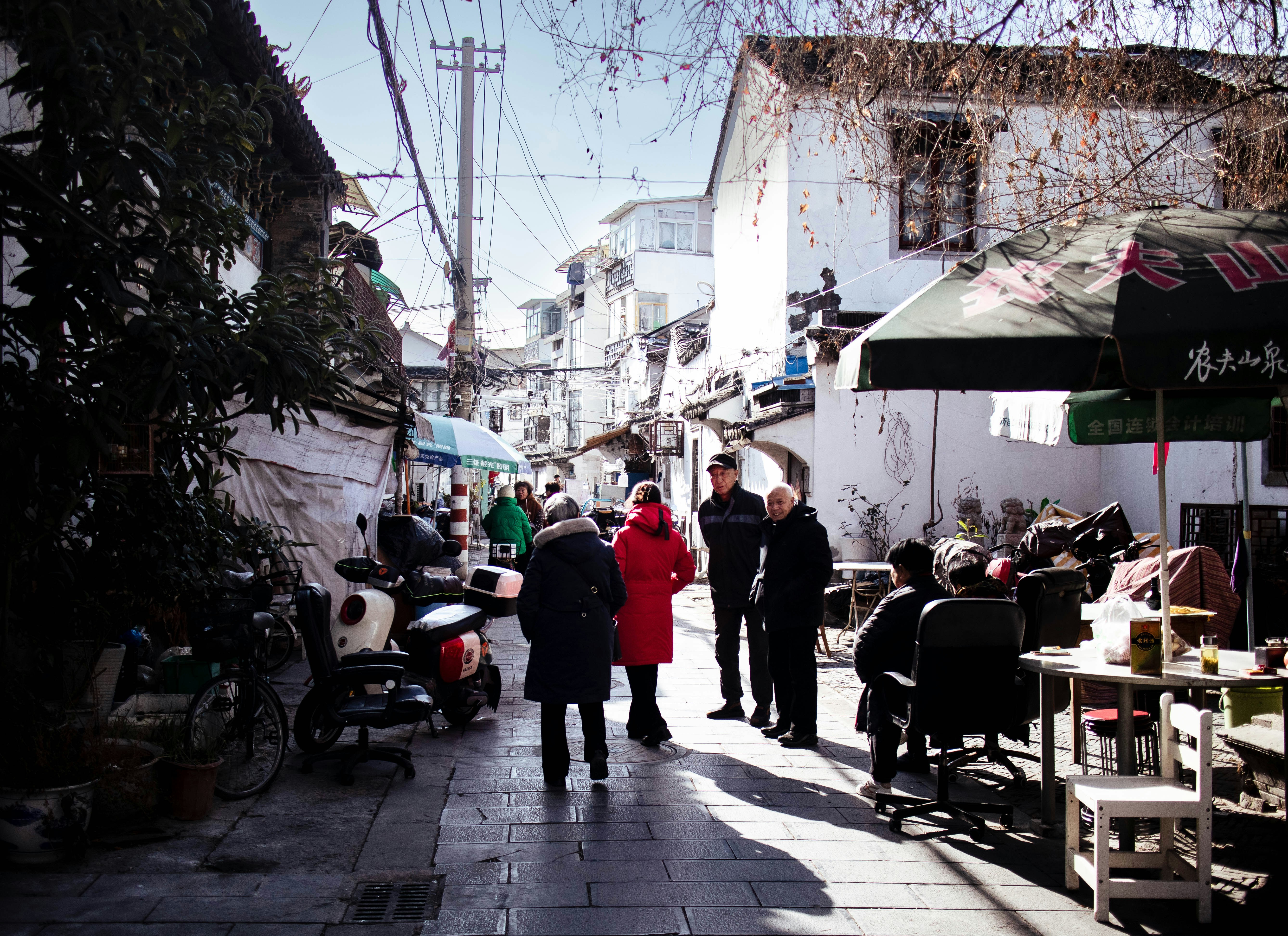 A group of people walking down a street