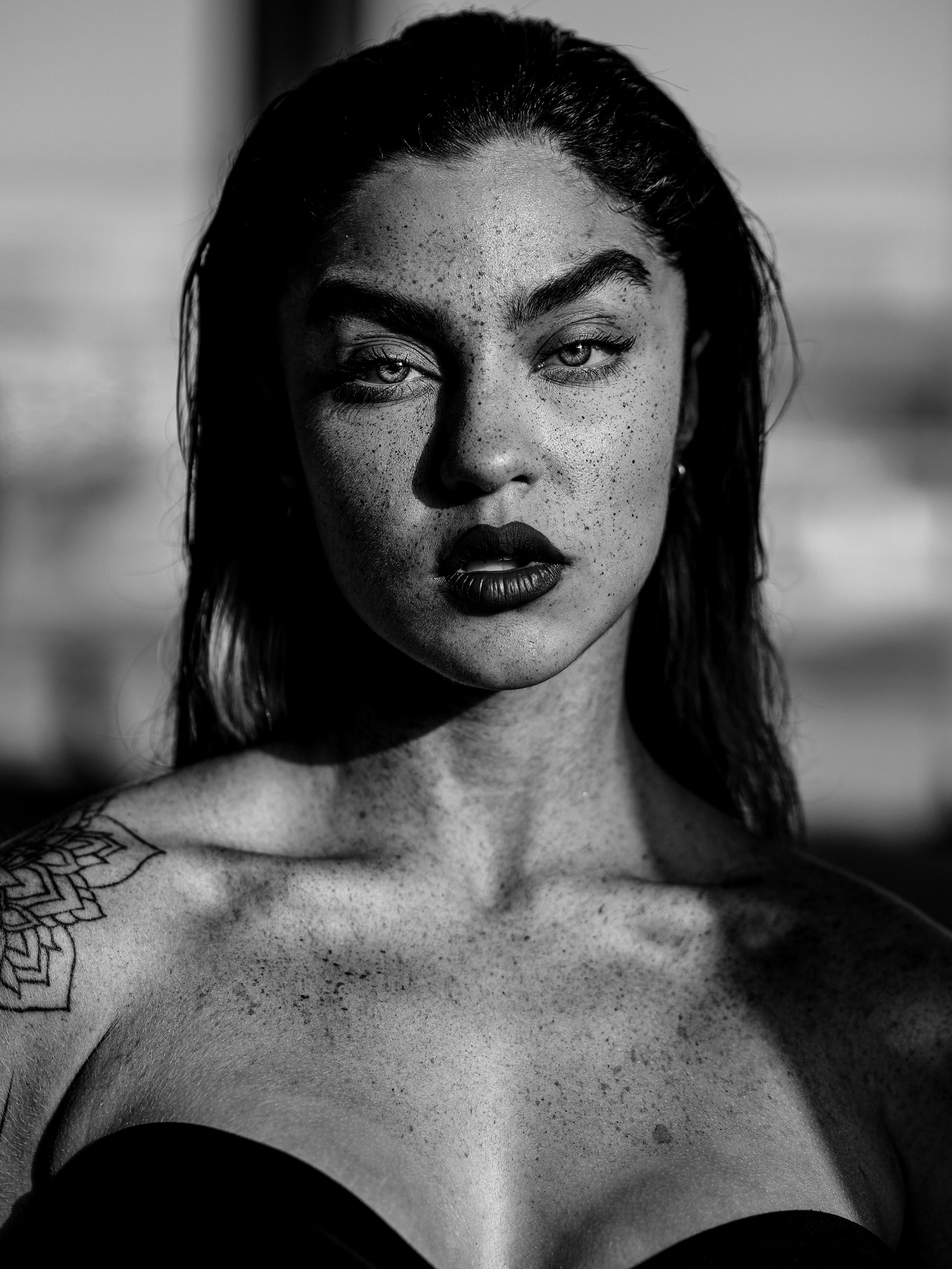 A black and white photo of a woman with tattoos