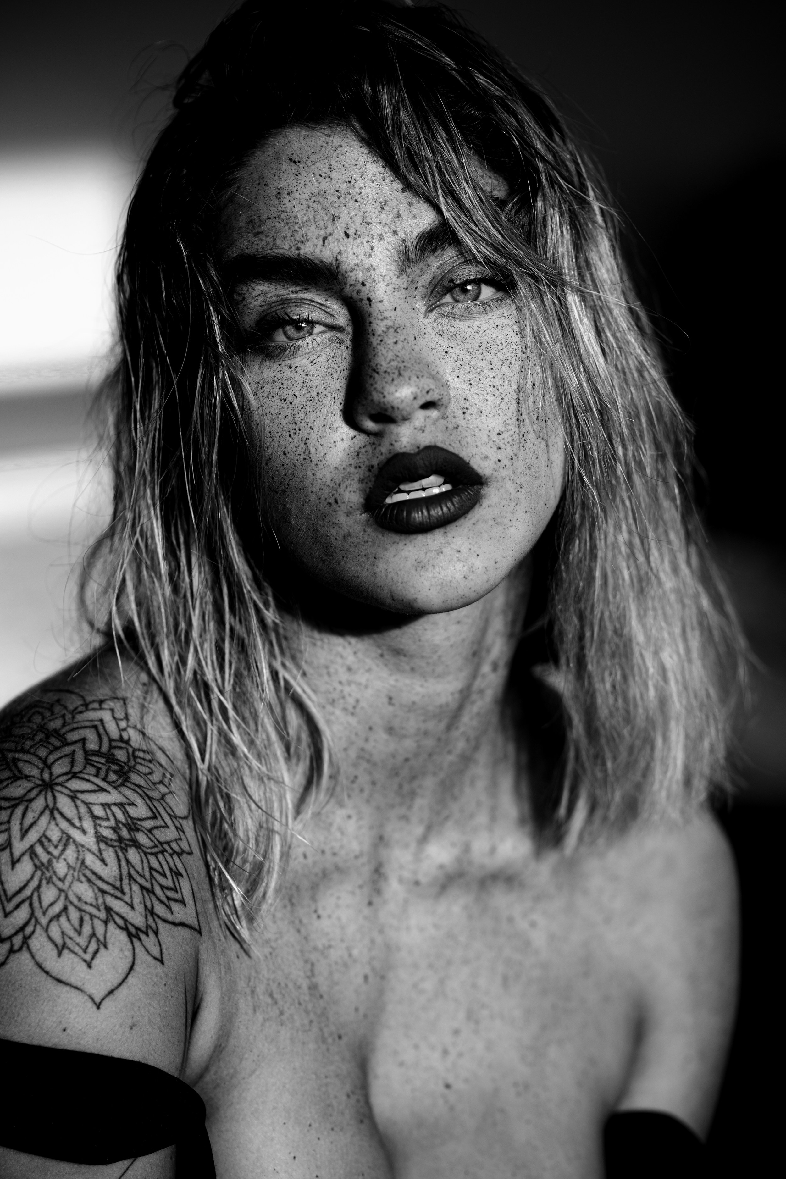 A black and white photo of a woman with freckled hair