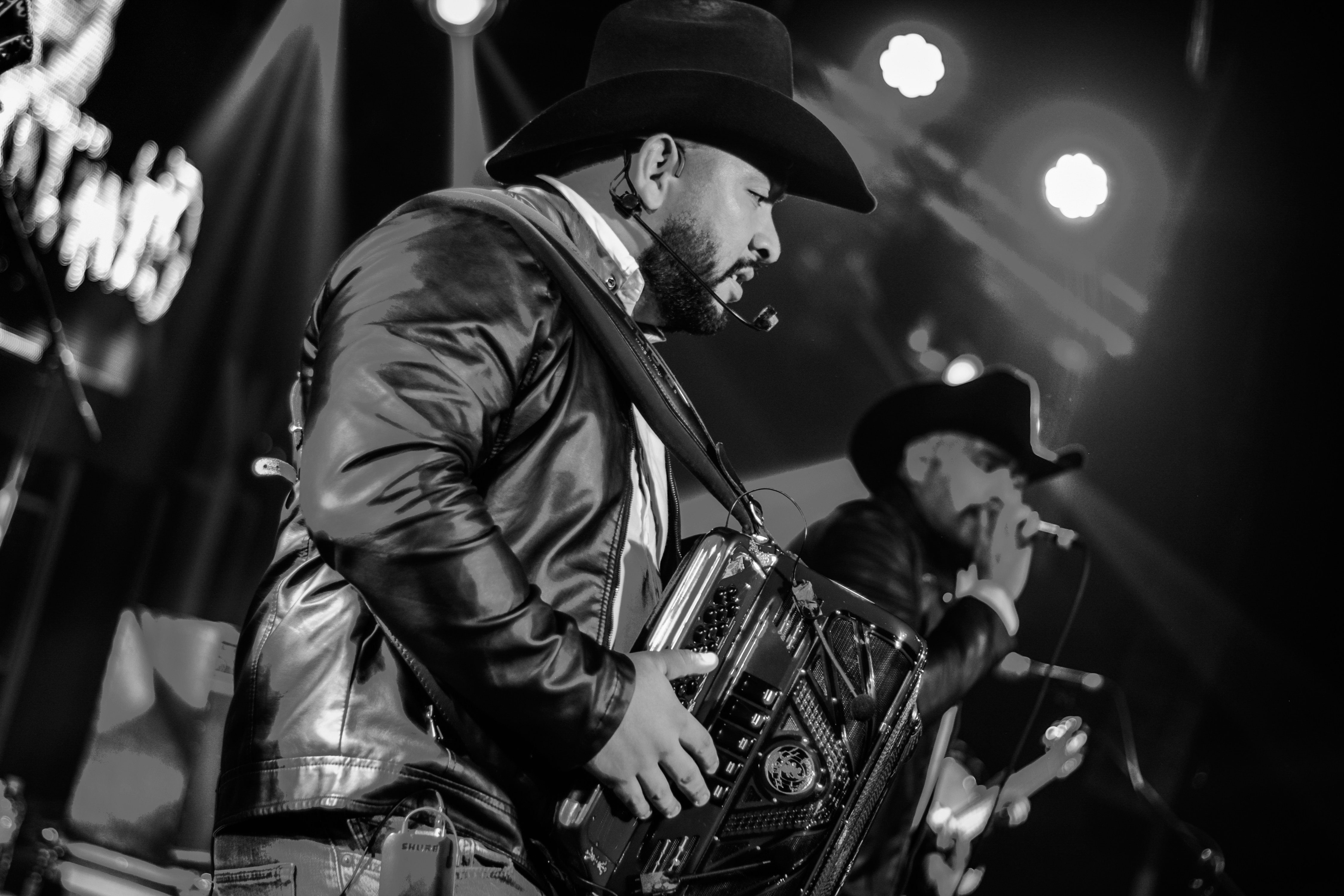 A man in a cowboy hat playing an accordion