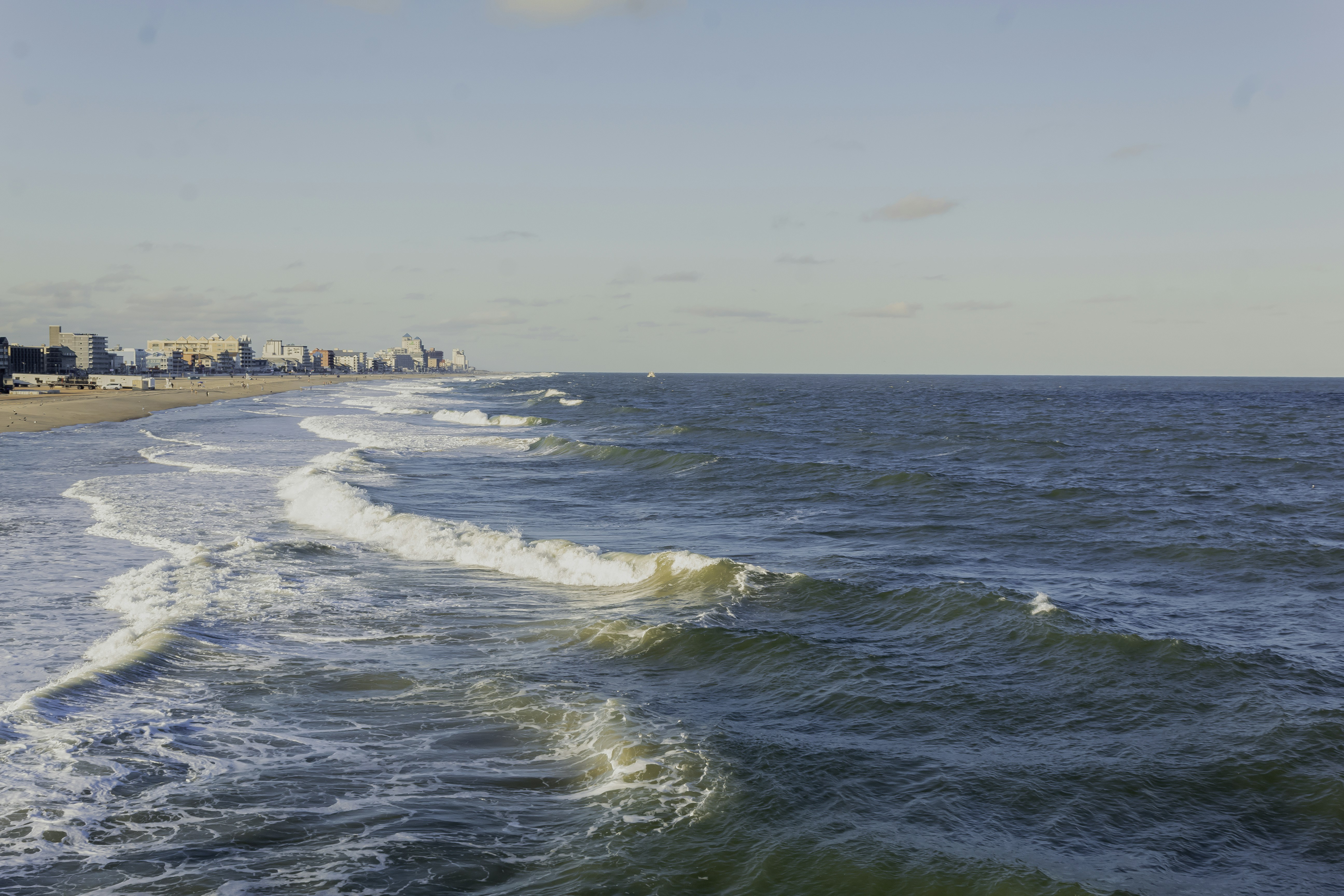 A view of a beach with a city in the distance