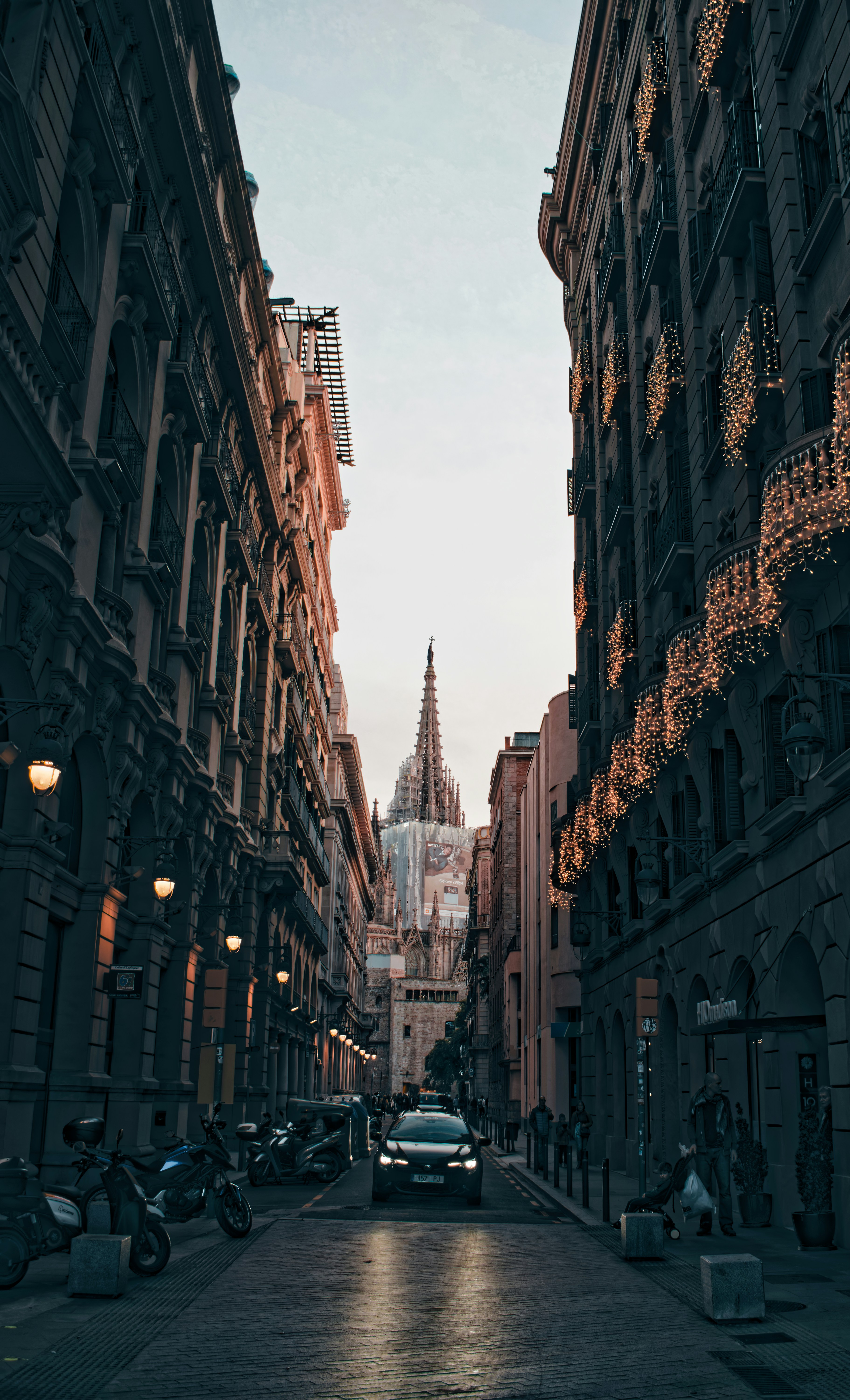 A narrow city street lined with tall buildings