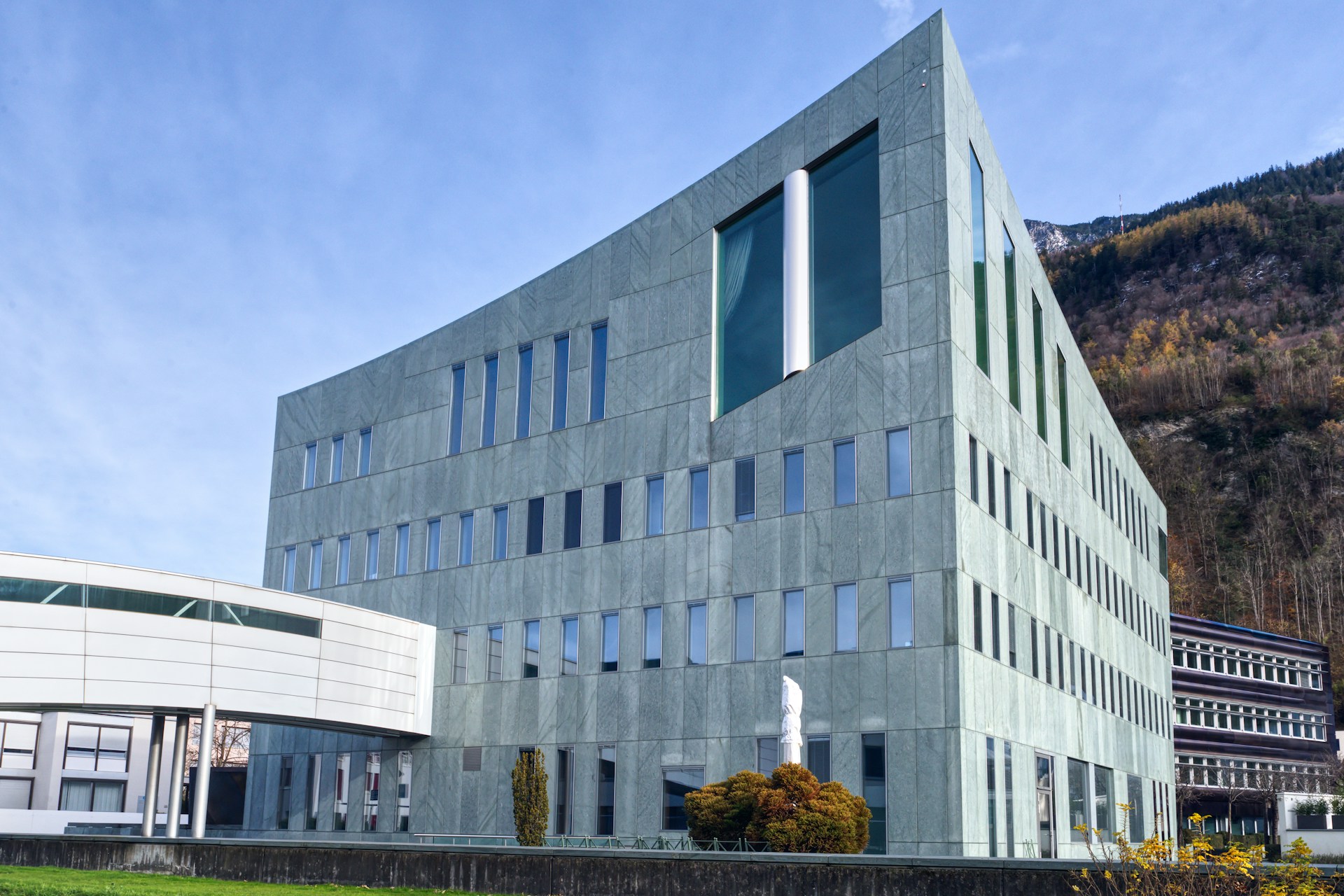 A large building with a green lawn in front of it