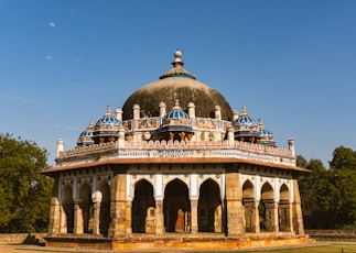 A large white and blue building with a sky background