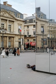 A reflection of a person laying on the ground in a mirror