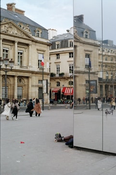 A reflection of a person laying on the ground in a mirror