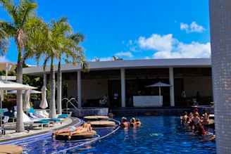 A group of people lounging in a swimming pool
