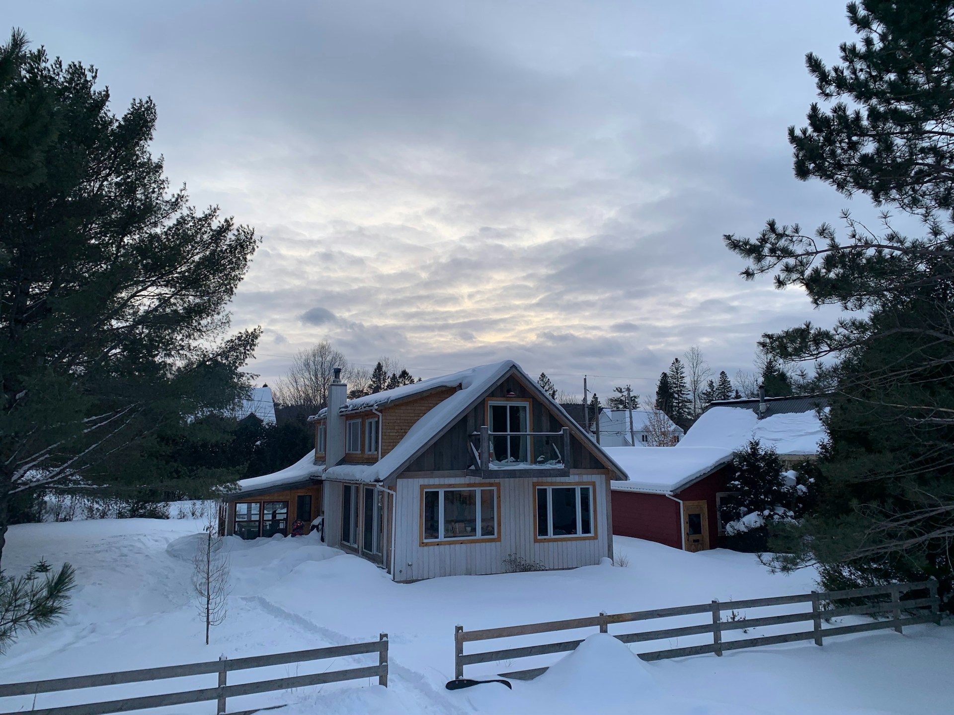 A house in the middle of a snowy field