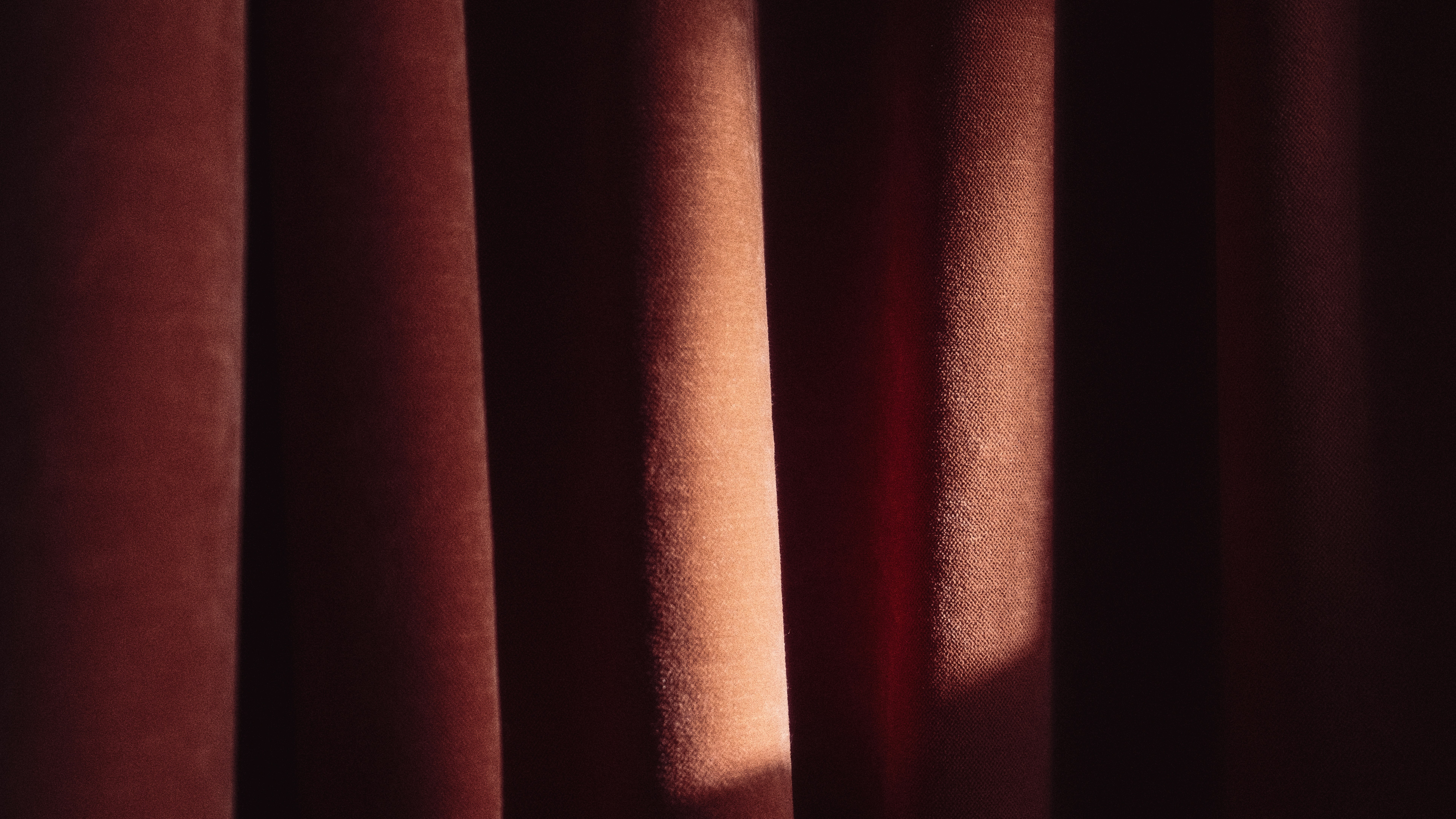 A close up of a curtain with the light coming through it
