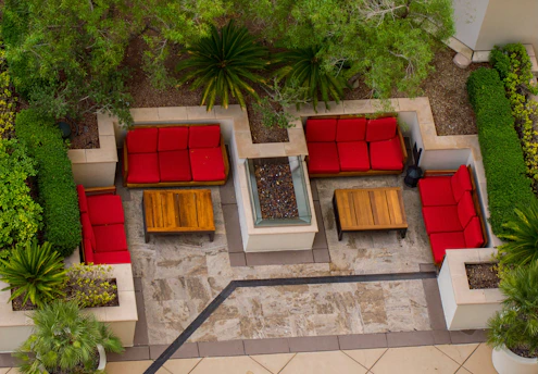 An aerial view of a patio with seating and trees