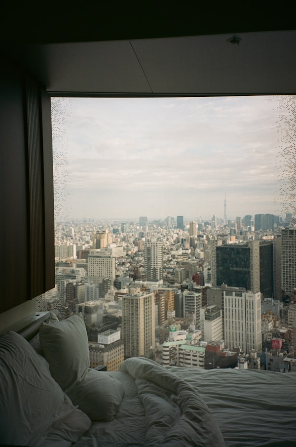 Tokyo — luxury suite with panoramic city view, evoking Aman Tokyo