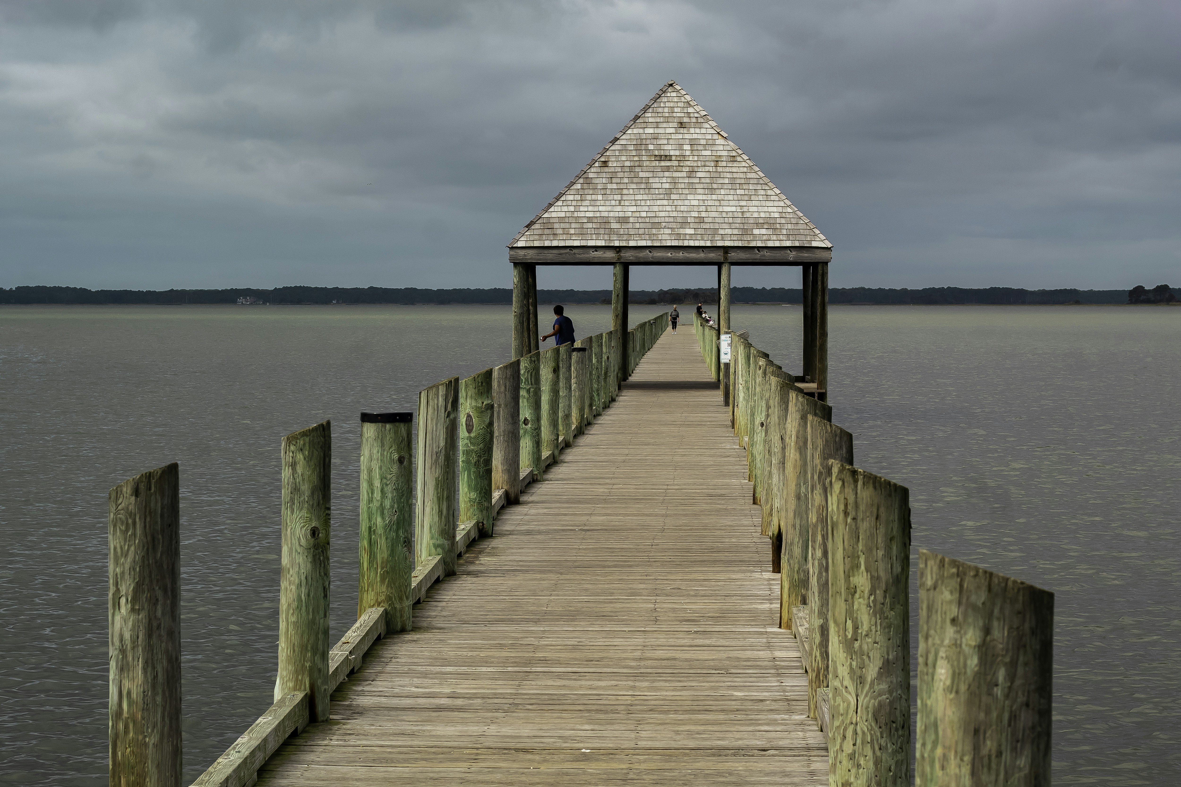 A wooden pier with a hut on top of it