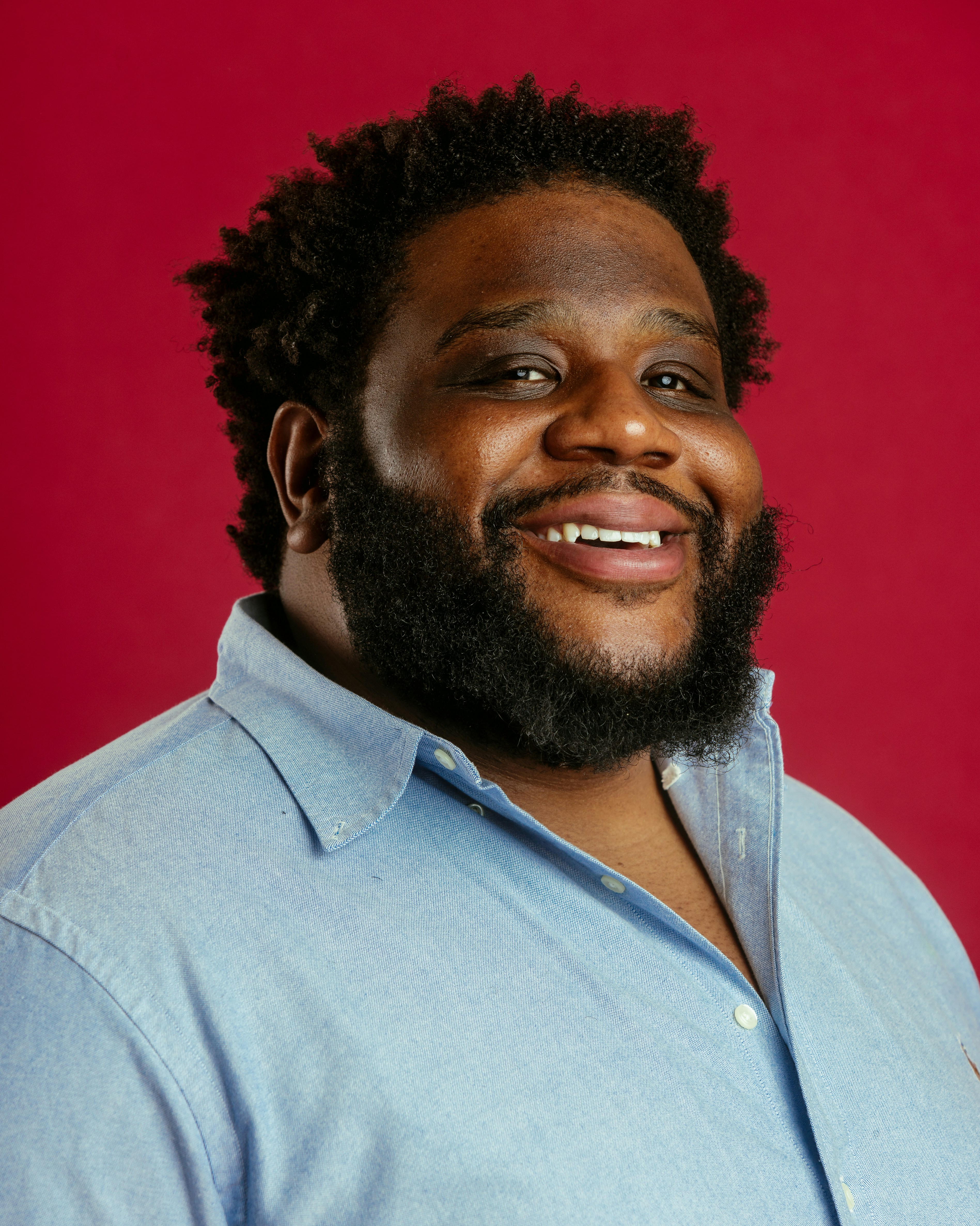 A man with a beard and a blue shirt