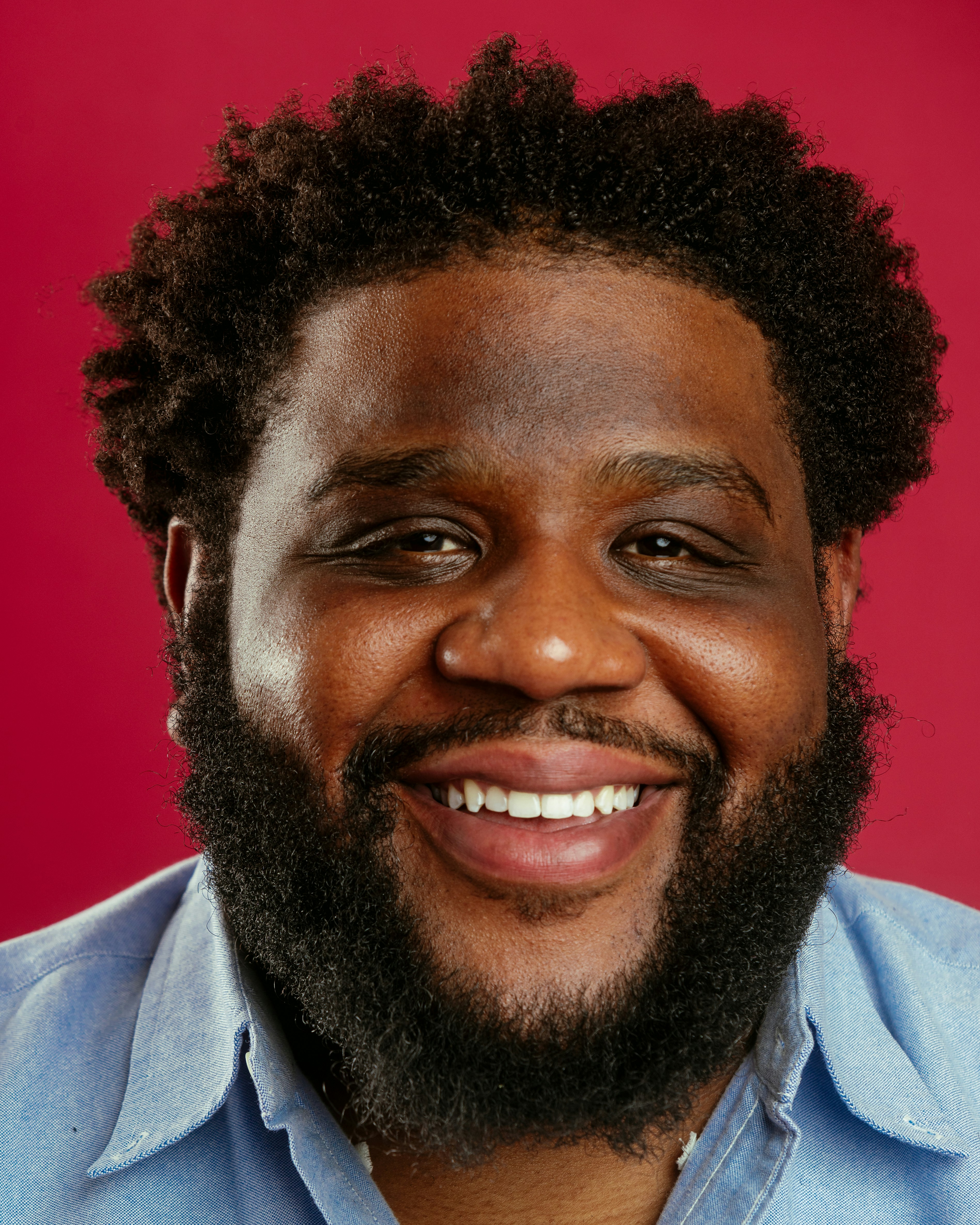A close up of a person wearing a blue shirt