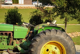 A green tractor parked in a parking lot
