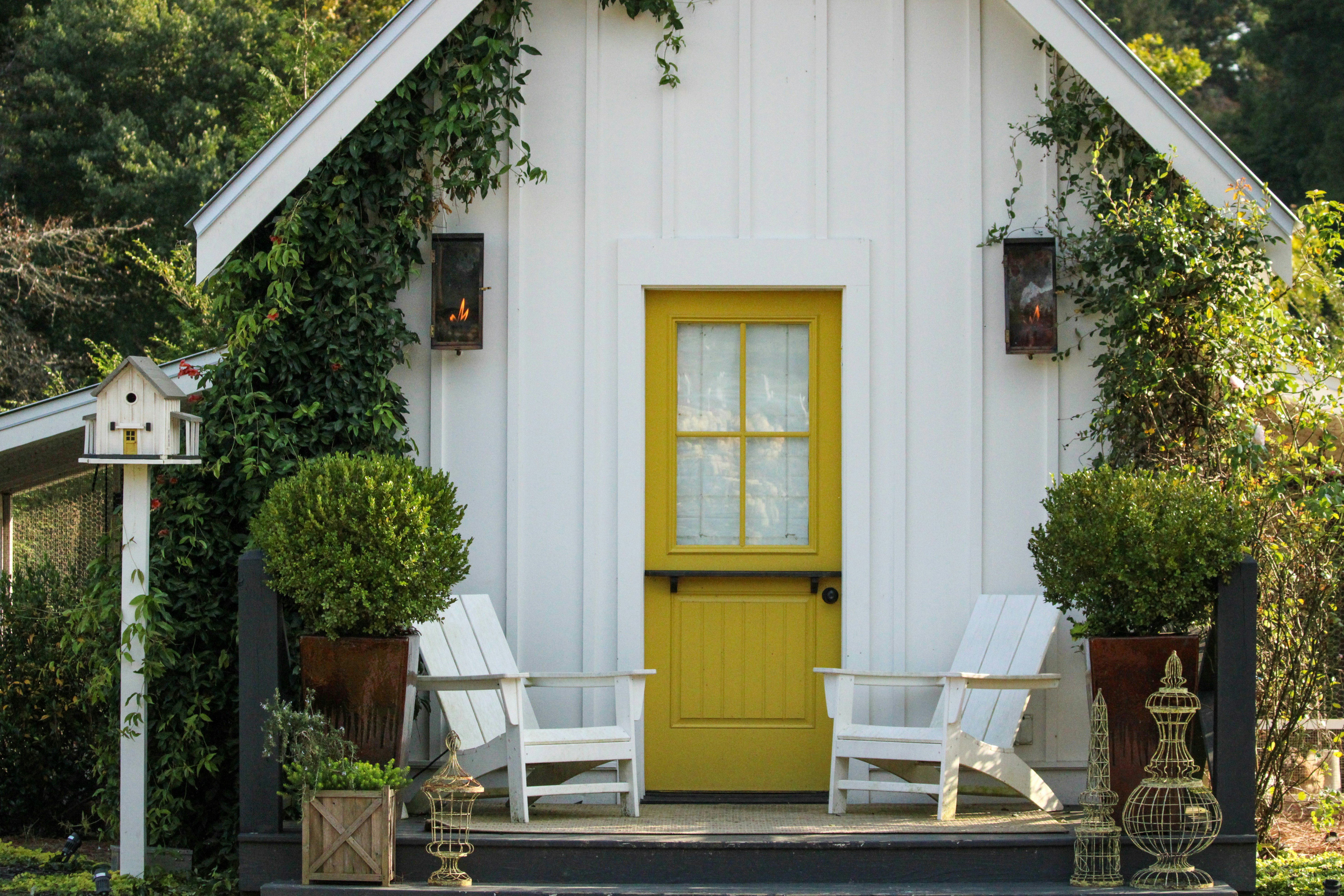 A small white house with a yellow door