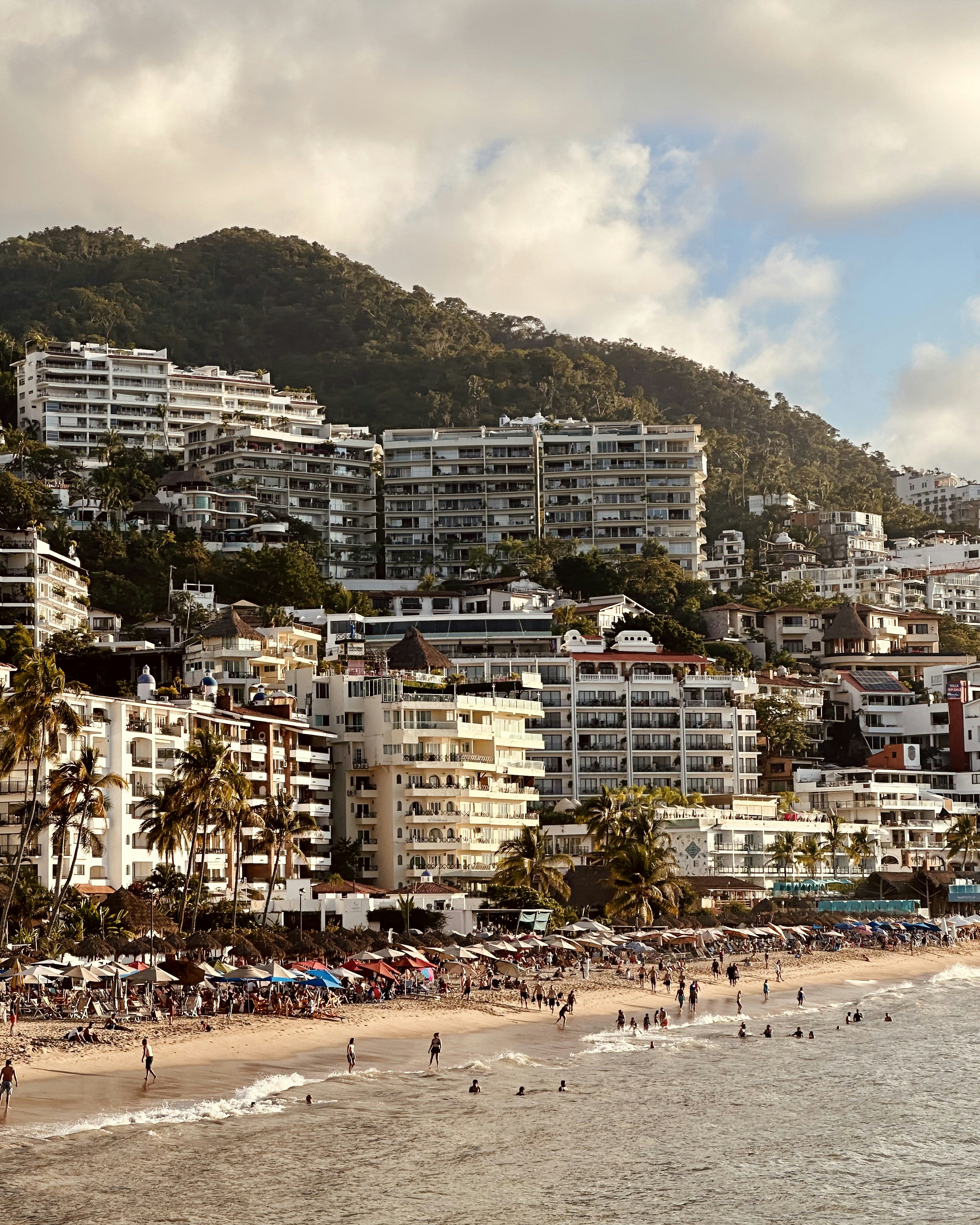 A beach that has a bunch of people on it