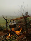 A tea kettle sitting on top of a fire