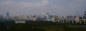A view of a city with a bridge in the foreground