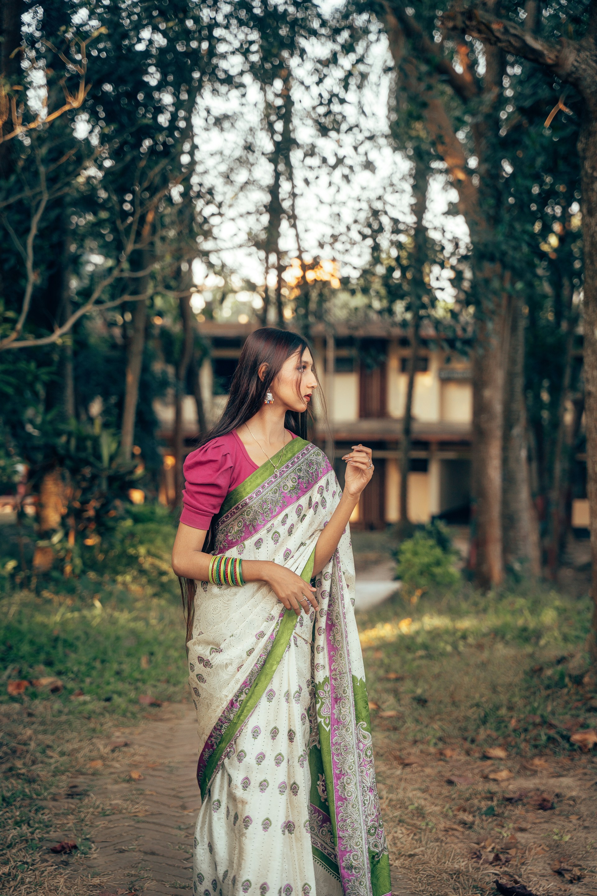 A woman in a white and green sari