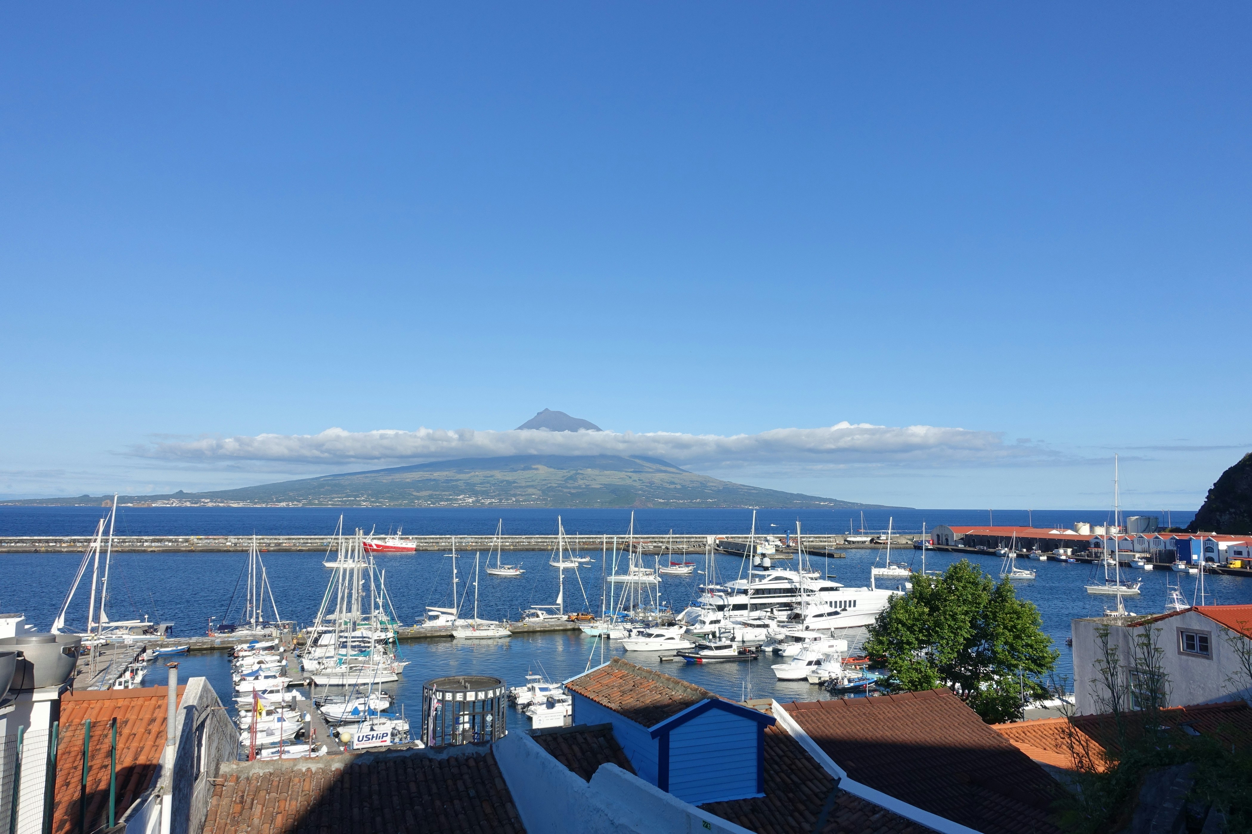 A harbor filled with lots of boats under a blue sky